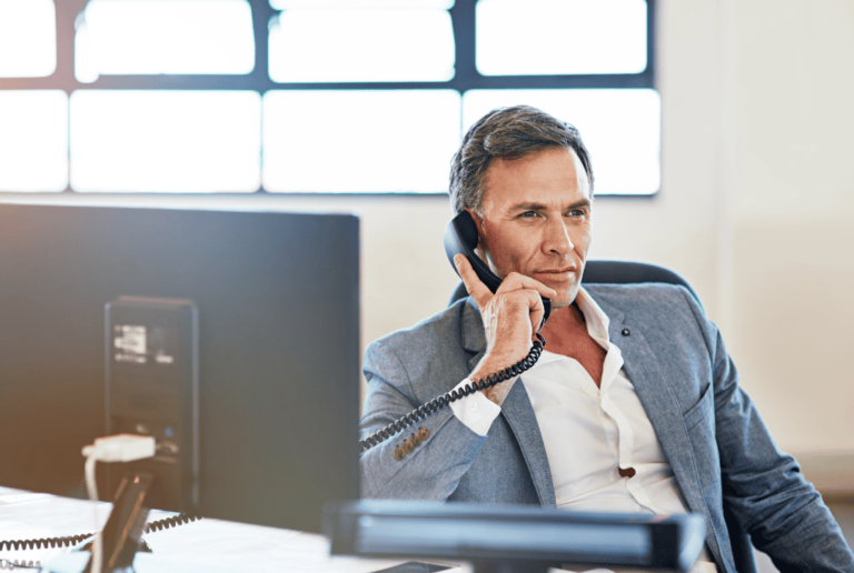 A man on the phone discussing client onboarding