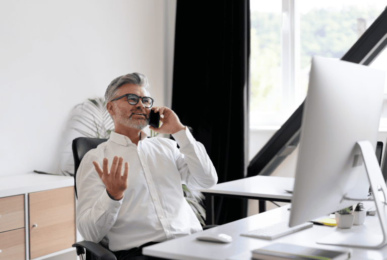 An employee discussing collaborative culture over the phone