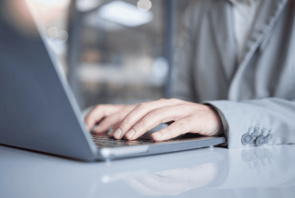 working on a laptop to ensure the execution of project deliverables and task completion