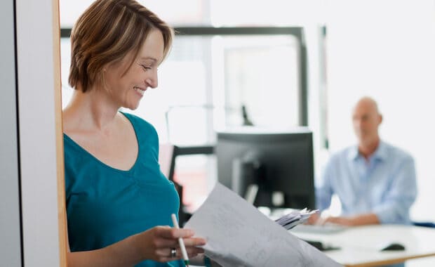 a female business owner looks through post project evaluation results