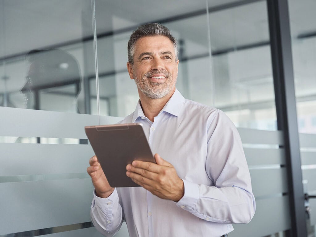 a male project manager doing project management evaluation via his device