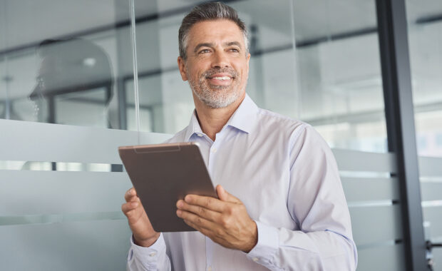 a male project manager going over project management mistakes on his device