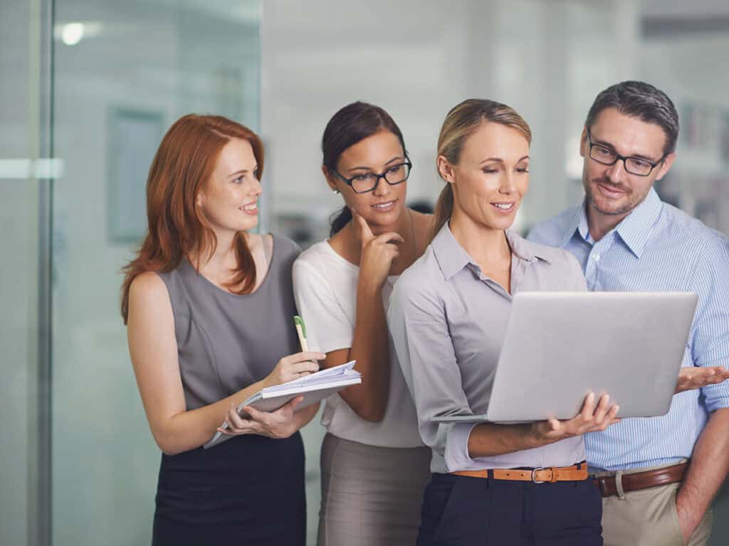 female project manager overcomes the challenges of delegation calmly as she assigns tasks to employees