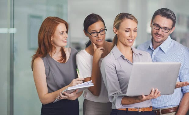 female project manager overcomes the challenges of delegation calmly as she assigns tasks to employees