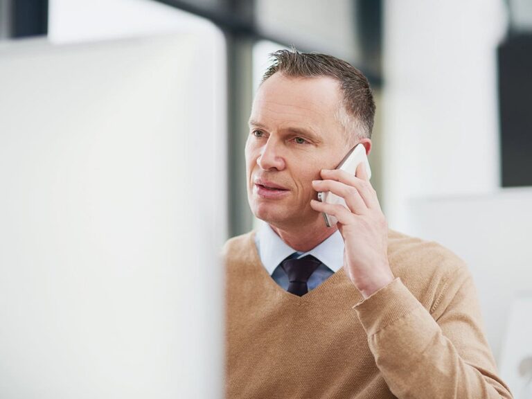 Business owner alleviating customer dissatisfaction by speaking with them over phone to re-evaluate worflow