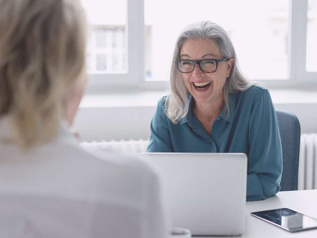 business owner and project manager creating a project management plan in a one-on-one meeting