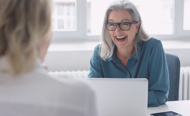 business owner and project manager creating a project management plan in a one-on-one meeting