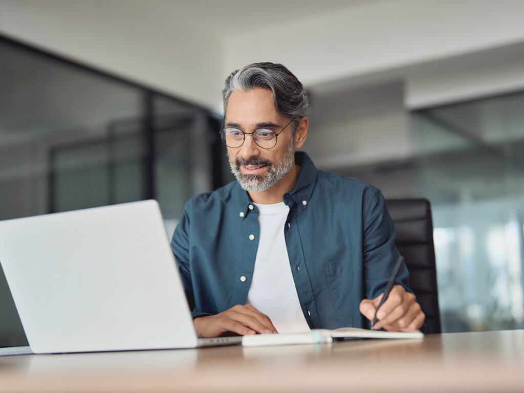 Small business owner doing a process audit via his laptop