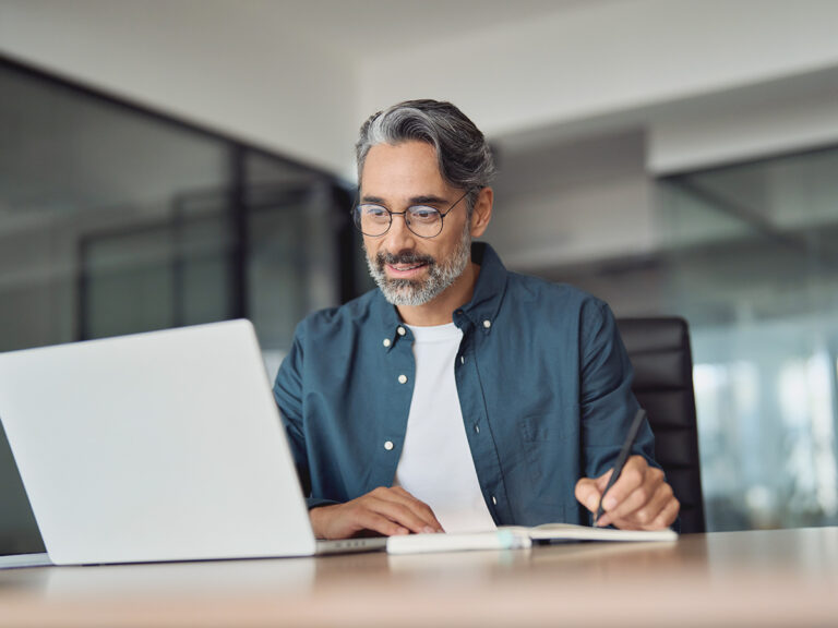 Small business owner doing a process audit via his laptop