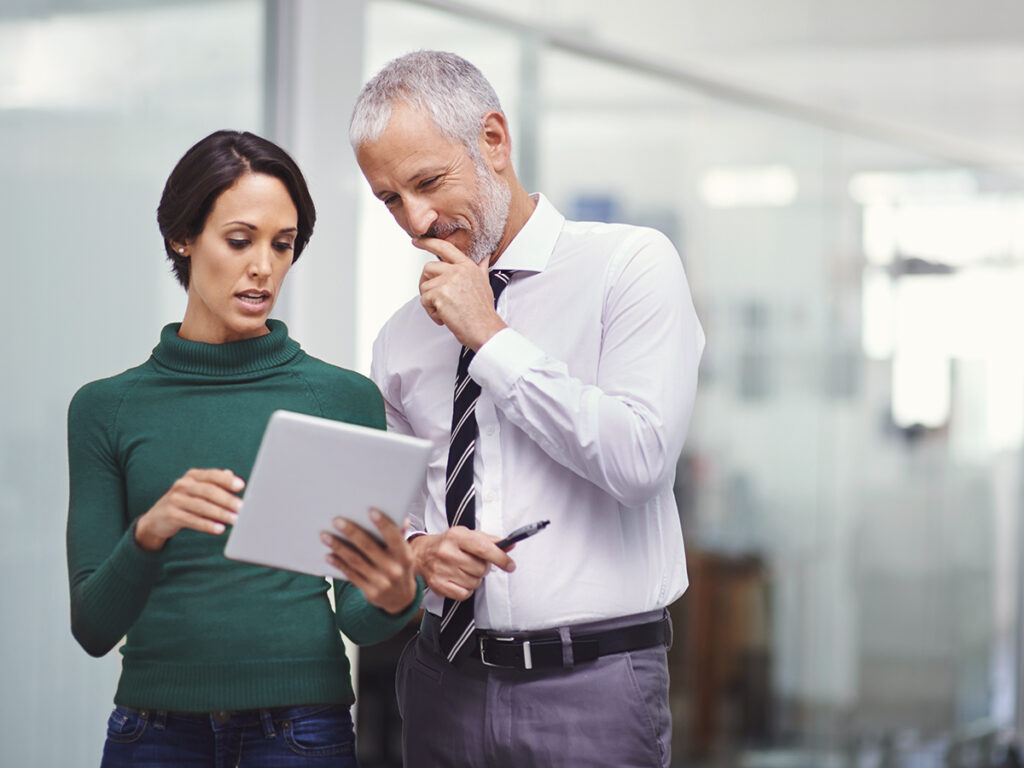 Two small business owners discussing project resource allocation