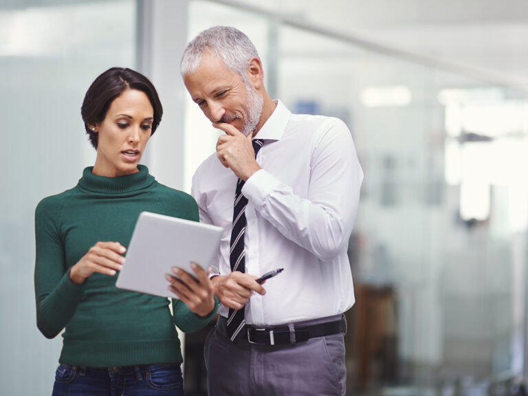Two small business owners discussing project resource allocation