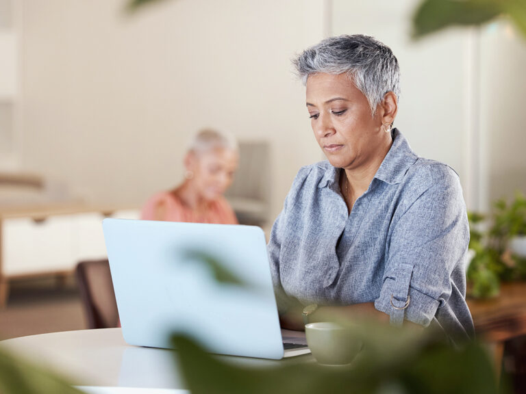 A female businesswoman researching about time management for business owners in a cafe