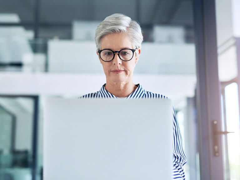 An overwhelmed business owner staring at the workload in her laptop