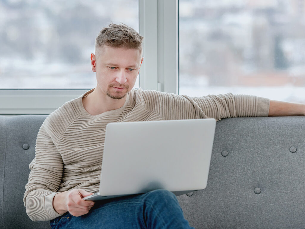 A business owner with his laptop checking on business bottlenecks