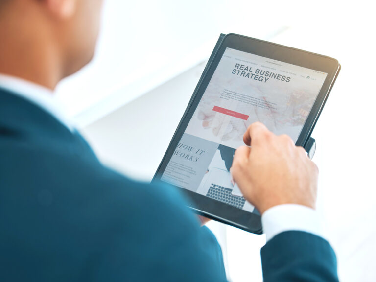an employee viewing a tablet that displays a business strategy and will look into business mistakes