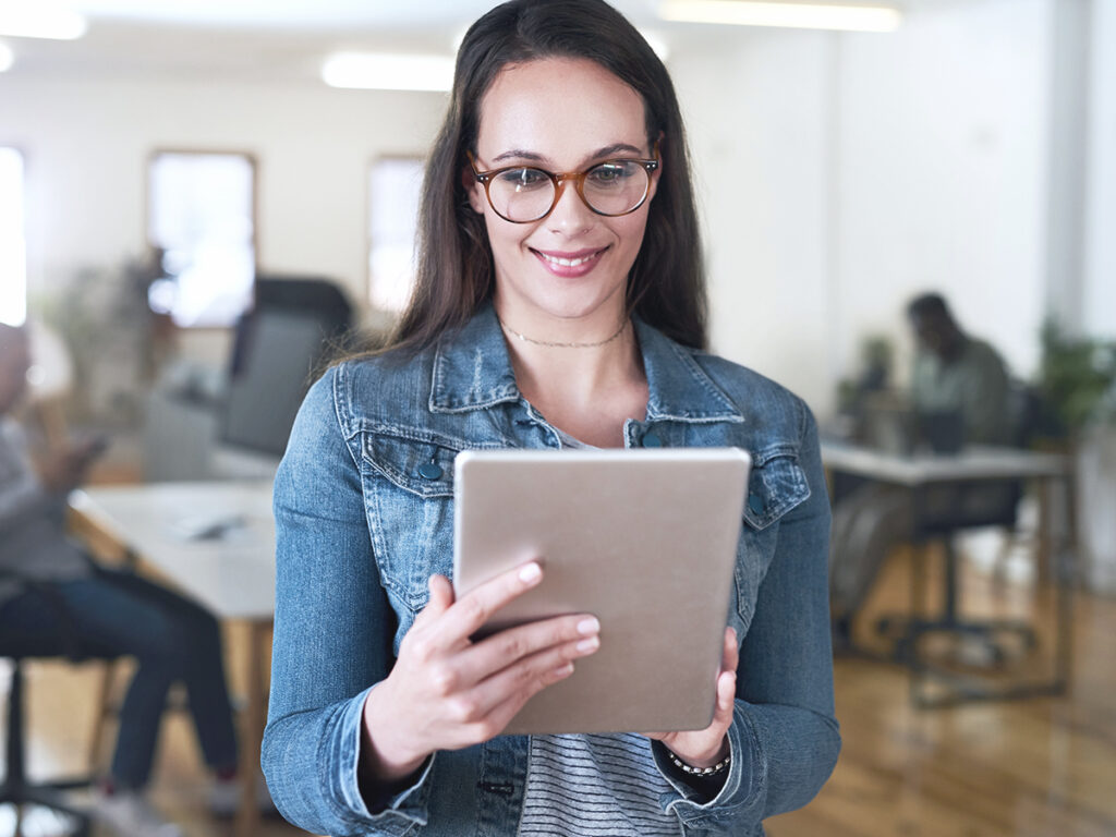 hr manager holding a tablet checking new hire tasks and instructions for the company's employee onboarding diligently