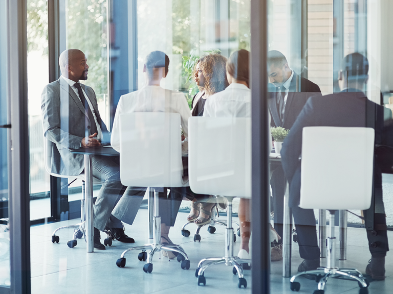Employees meeting to improve a repeatable process for consistent business operations.